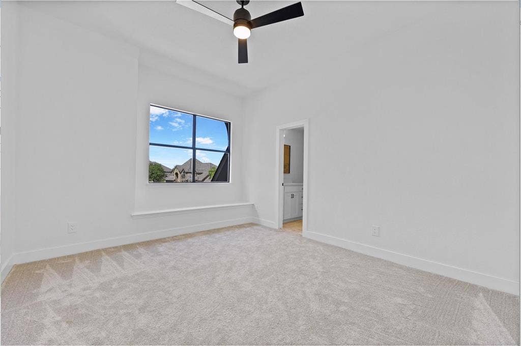 1750 Greenwood Court, Prosper, TX 75078 Carpeted room with a black ceiling fan, a window with exterior views, and a white interior door