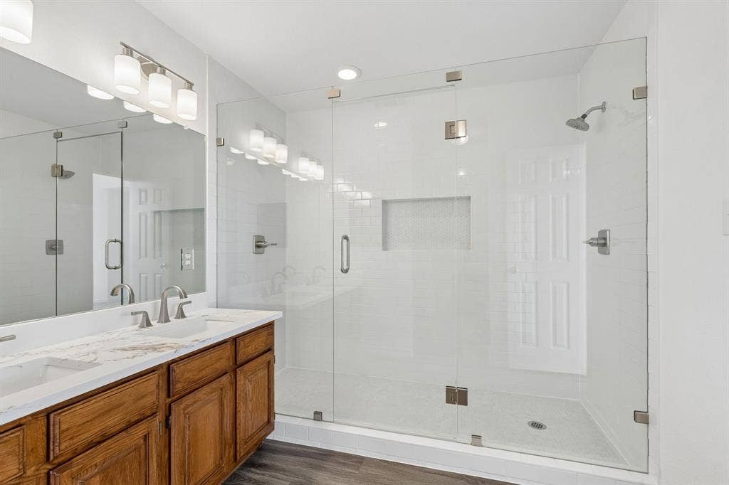 1609 Blackburn Road, Sachse, TX 75048 Custom oversized walk in shower in primary bath gives you two shower heads and shampoo niche