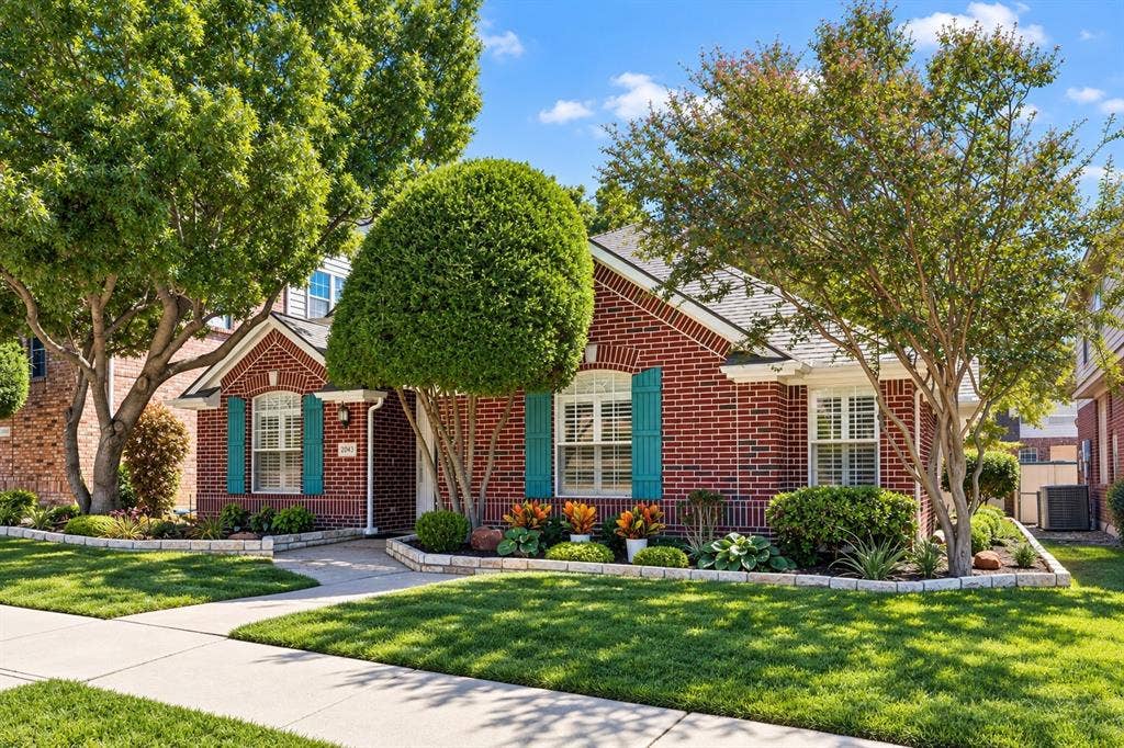 Fresh landscaping and Zoysia grass provide excellent curb appeal