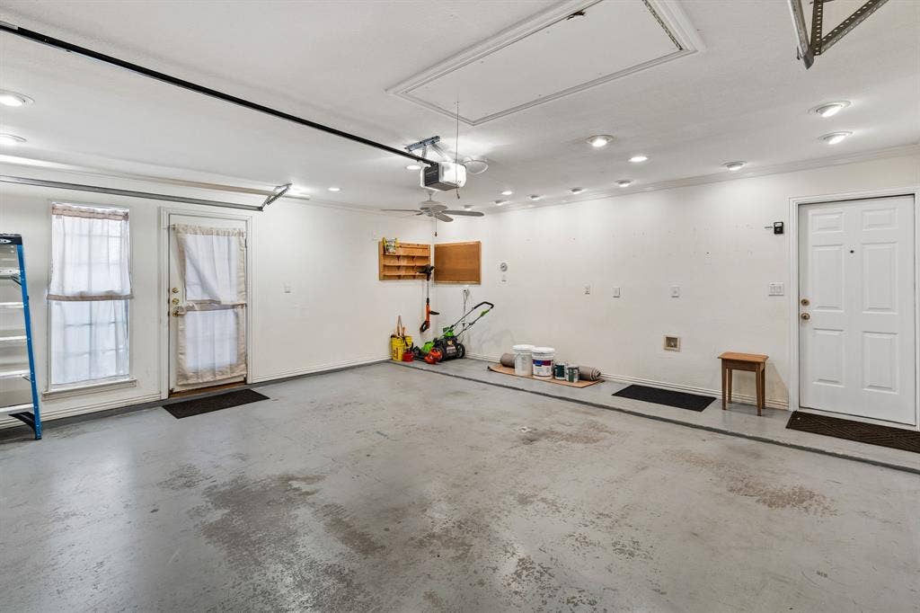 Garage has 220v connection, custom lighting, and door to side yard