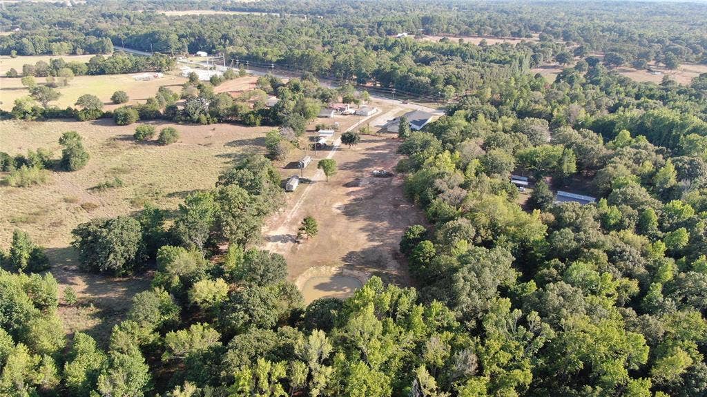 7544 N US HIGHWAY 69 Highway, Alba, TX 75410 Expansive wooded acreage featuring a natural pond and clearings