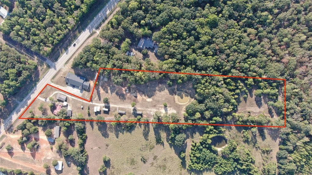 7544 N US HIGHWAY 69 Highway, Alba, TX 75410 Extensive acreage featuring natural tree coverage, multiple structures, and a prominent roadway frontage