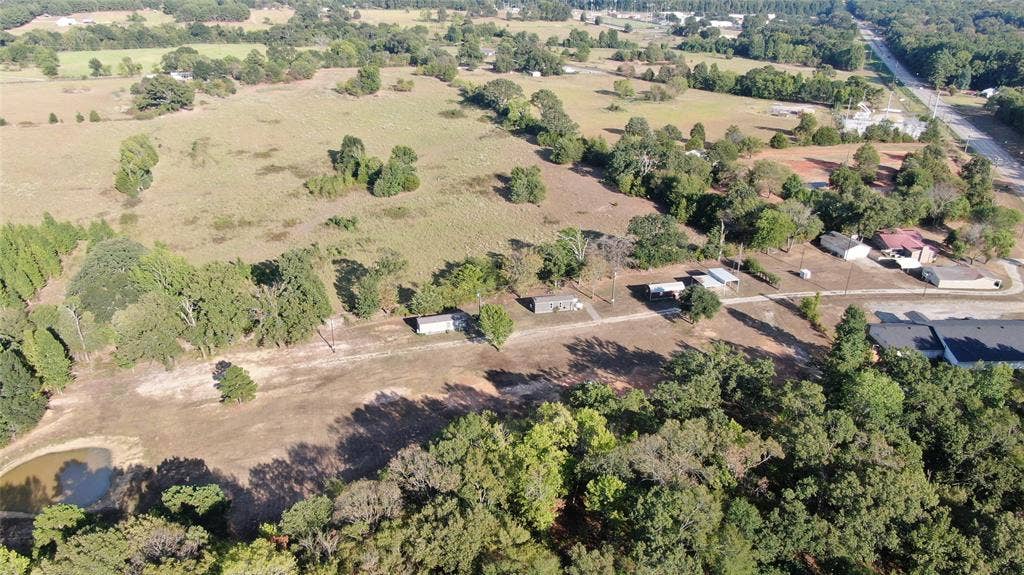 7544 N US HIGHWAY 69 Highway, Alba, TX 75410 Expansive open fields, multiple mature trees, and a visible pond