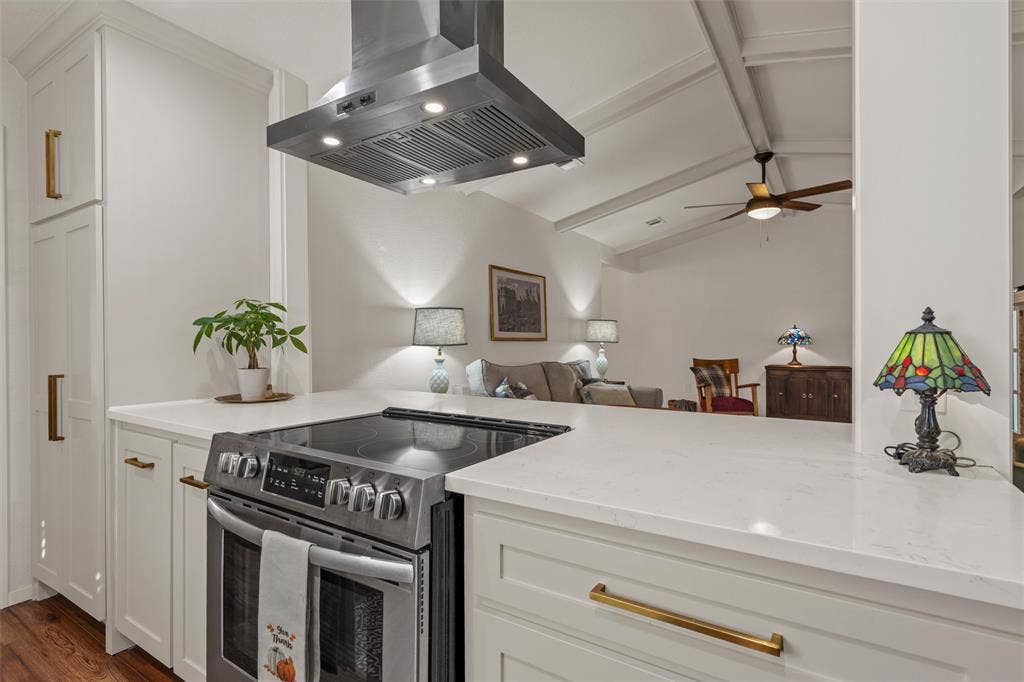 1712 Laurel Lake Drive, Waco, TX 76710 Stainless steel range with a coordinating range hood, white cabinetry, and light-toned countertops