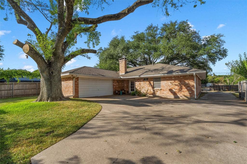 1712 Laurel Lake Drive, Waco, TX 76710 Brick exterior with a shingled roof, attached garage, and a concrete driveway