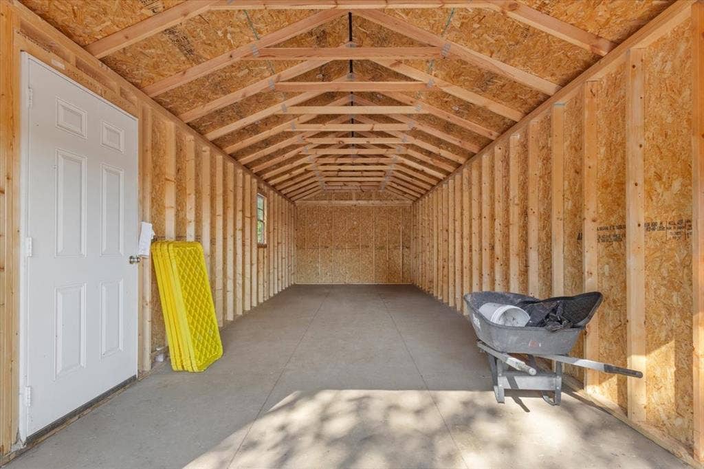 4246 Old Caufield Ranch Road, McGregor, TX 76657 Second spacious 32 x12 ft storage building featuring exposed wood-frame, concrete flooring, and a side entry door