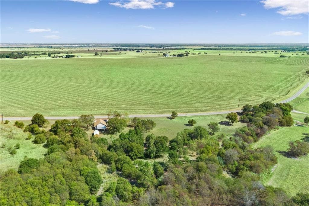 4246 Old Caufield Ranch Road, McGregor, TX 76657 Expansive rural property featuring lush green pastureland with established tree lines and mature vegetation throughout