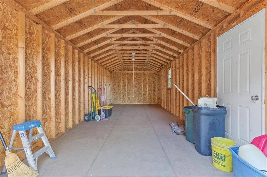 4246 Old Caufield Ranch Road, McGregor, TX 76657 First spacious 32 x12 ft storage building featuring exposed wood-frame, concrete flooring, and a side entry door