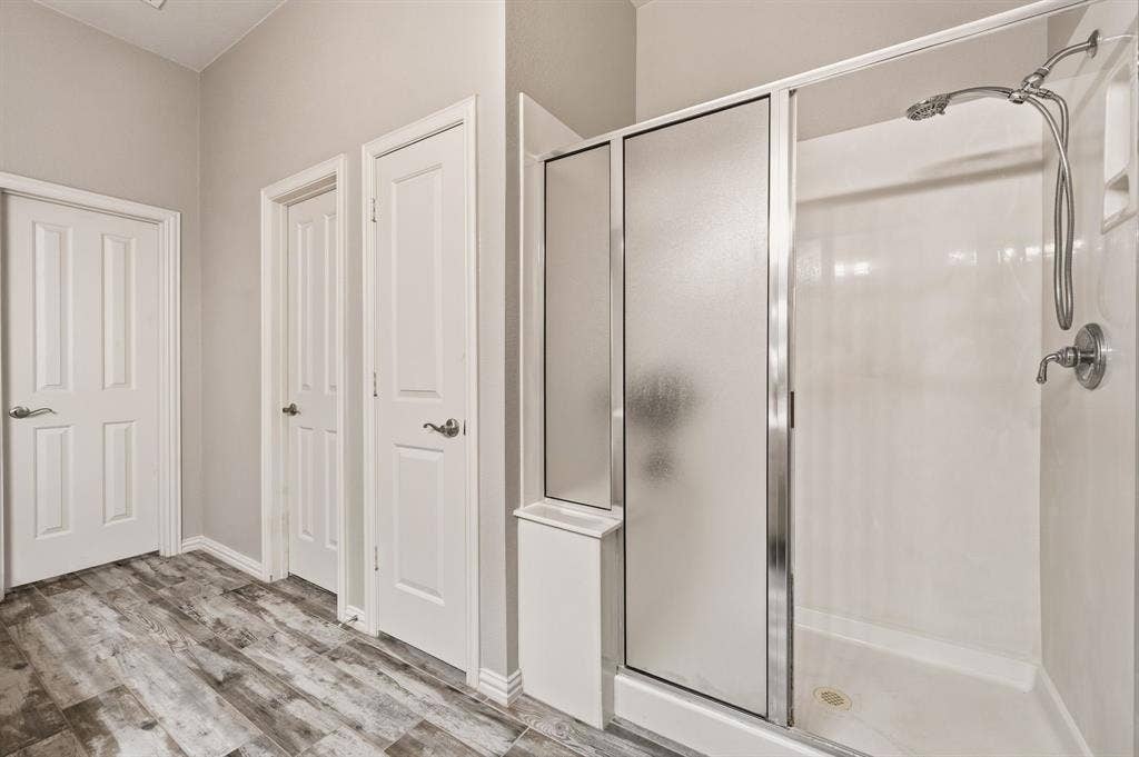 307 Park Haven Boulevard, Euless, TX 76039 Walk-in shower with a frosted glass enclosure and a built-in shelf