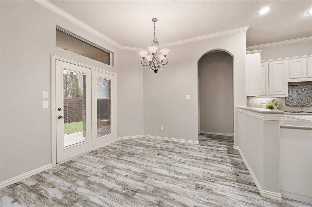 307 Park Haven Boulevard, Euless, TX 76039 Wood-finish flooring, French doors with transom window, arched entryway, white cabinetry, and recessed lighting