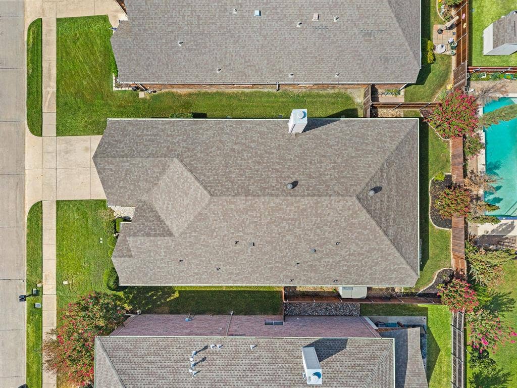 307 Park Haven Boulevard, Euless, TX 76039 Gable roof with asphalt shingles, concrete driveway, and manicured lawn