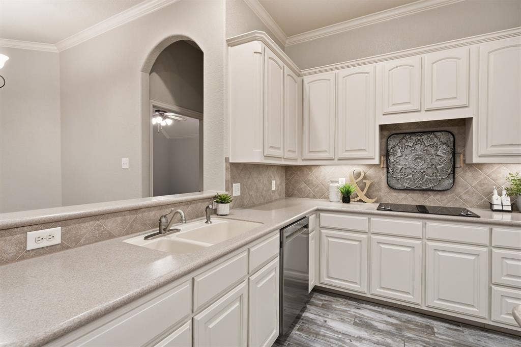 307 Park Haven Boulevard, Euless, TX 76039 White cabinetry with brushed nickel hardware, light-toned countertops, and a tiled backsplash