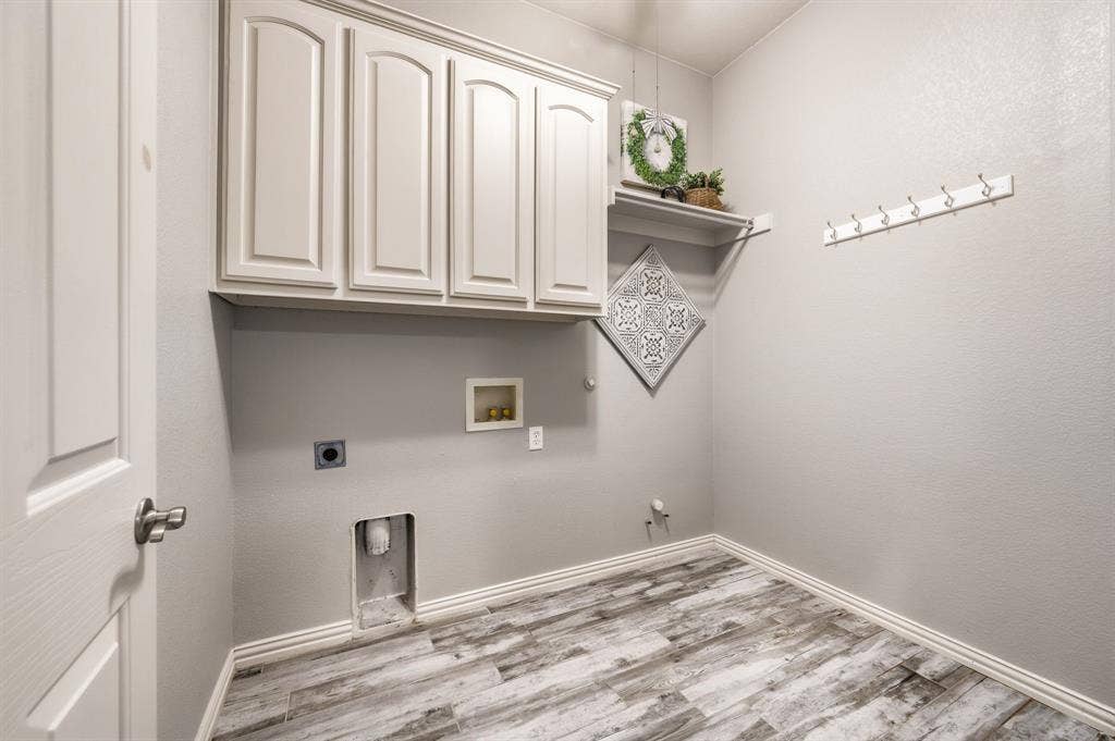 307 Park Haven Boulevard, Euless, TX 76039 Upper cabinetry, wood-finish flooring, white trim, wall-mounted shelving, and wall-mounted hooks