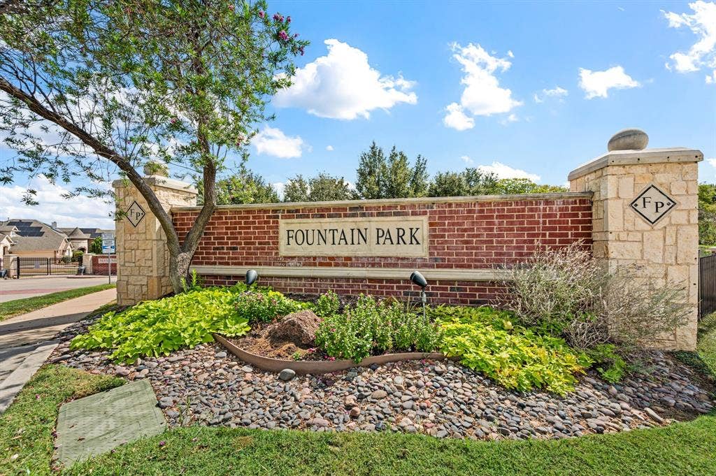 307 Park Haven Boulevard, Euless, TX 76039 Brick and stone entry monument featuring landscaping with varied plantings and ground cover, and a decorative rock bed