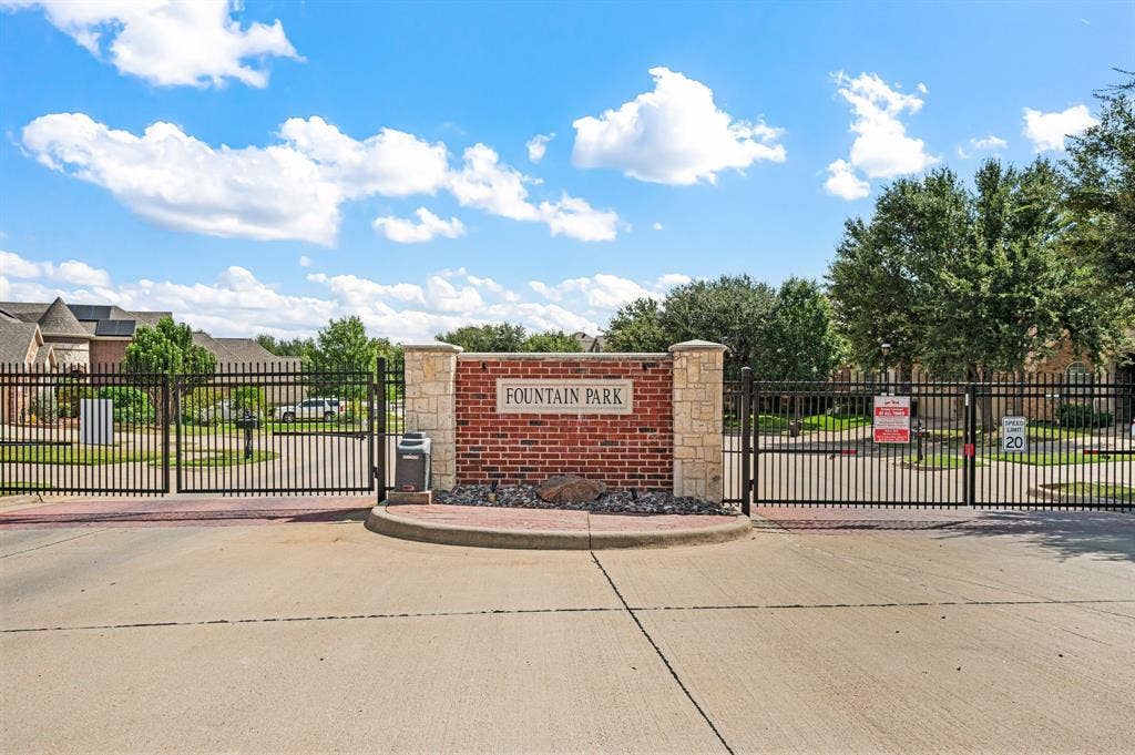 307 Park Haven Boulevard, Euless, TX 76039 Gated community entrance with brick and stone pillar signage