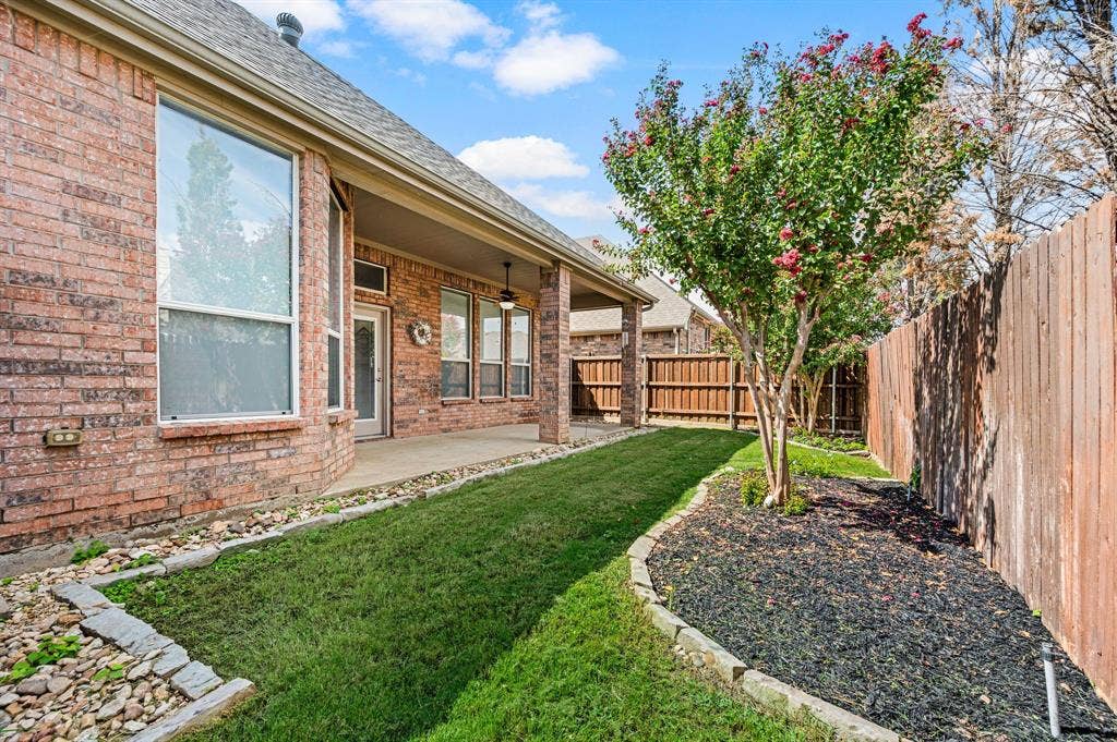 307 Park Haven Boulevard, Euless, TX 76039 Brick exterior with multiple windows and a covered patio