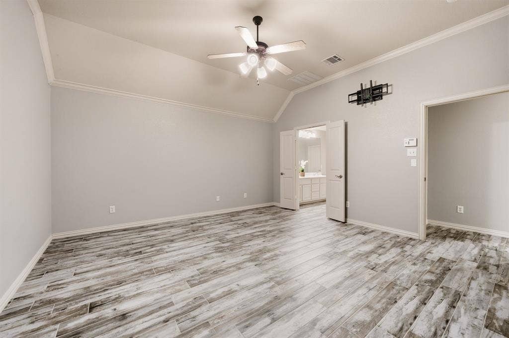 307 Park Haven Boulevard, Euless, TX 76039 Vaulted ceiling with crown molding, ceiling fan, wood-finish flooring, and double doors