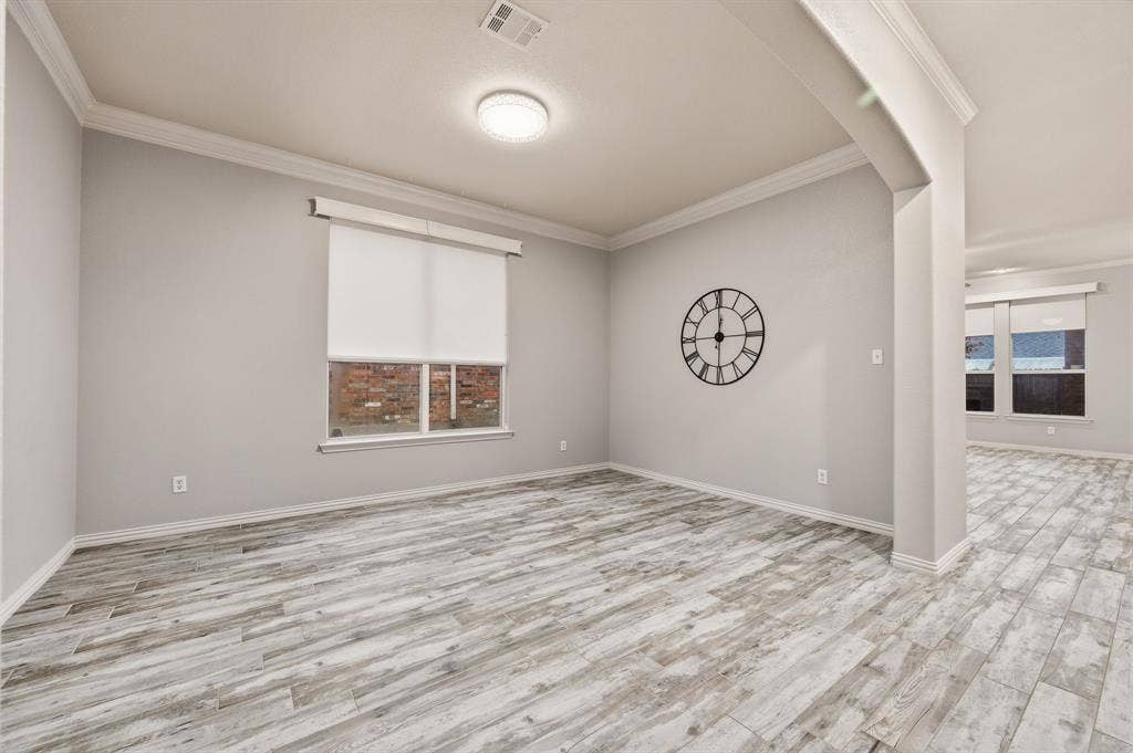 307 Park Haven Boulevard, Euless, TX 76039 Wood-finish flooring, crown molding, recessed lighting, neutral wall tones, and window with roller shade