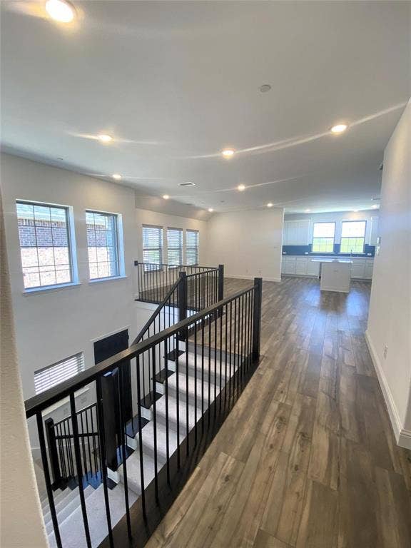 7297 Sacaton Trail, Frisco, TX 75033 Hallway Leading Out to Living, Dining, and Kitchen From Primary Suite