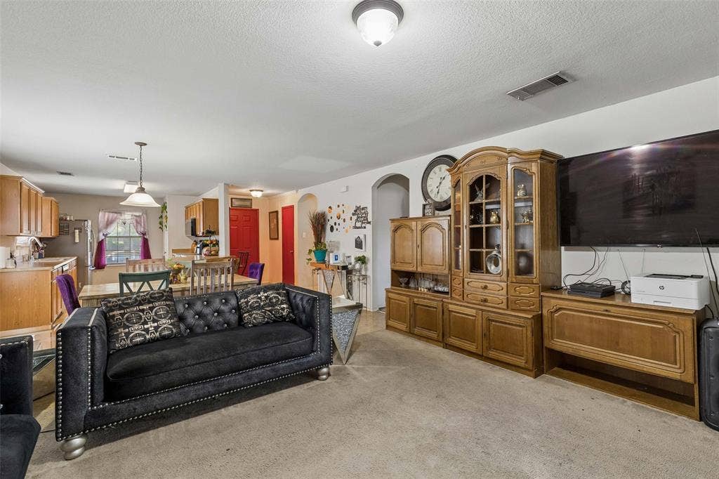 3118 Rosslynn Court, Seagoville, TX 75159 Open-concept living area with consistent flooring, recessed ceiling lighting, and archway entry