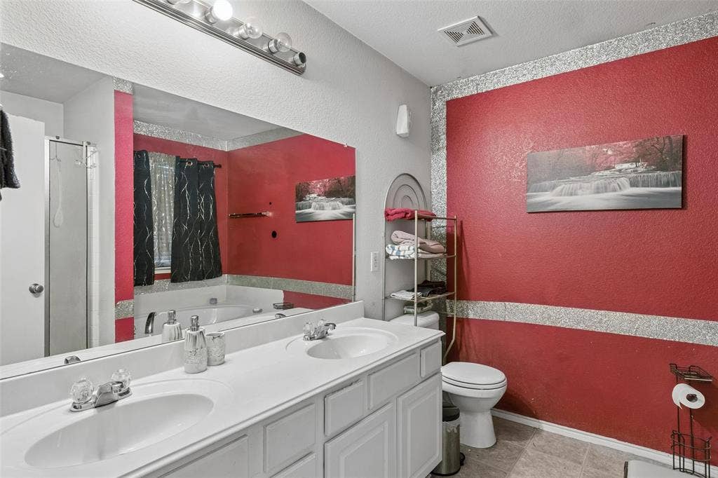 3118 Rosslynn Court, Seagoville, TX 75159 Dual vanity with integrated sinks, full-width mirror, recessed lighting, and a built-in bathtub