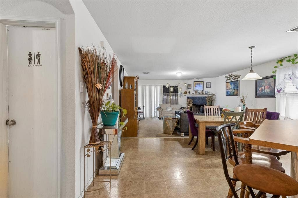 3118 Rosslynn Court, Seagoville, TX 75159 Open-concept living space with hard-surface flooring and a fireplace feature