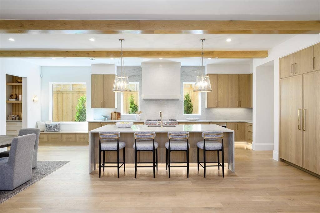 3929 Stanford Avenue, University Park, TX 75225 Gourmet culinary kitchen with custom slim Shaker, white oak cabinetry with soft-close doors and drawers, natural stone countertops with waterfall detail at island