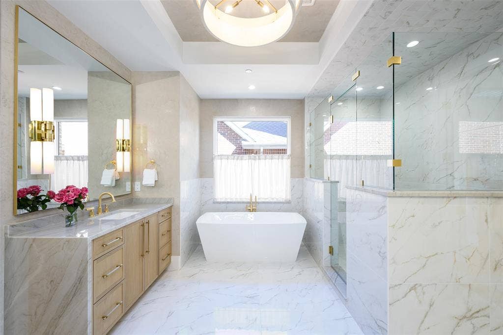 3929 Stanford Avenue, University Park, TX 75225 Primary bath with Venetian plaster walls, waterfall-style stone countertops and white oak soft-close cabinetry, free standing tub, walk-in shower and walk-in custom closet