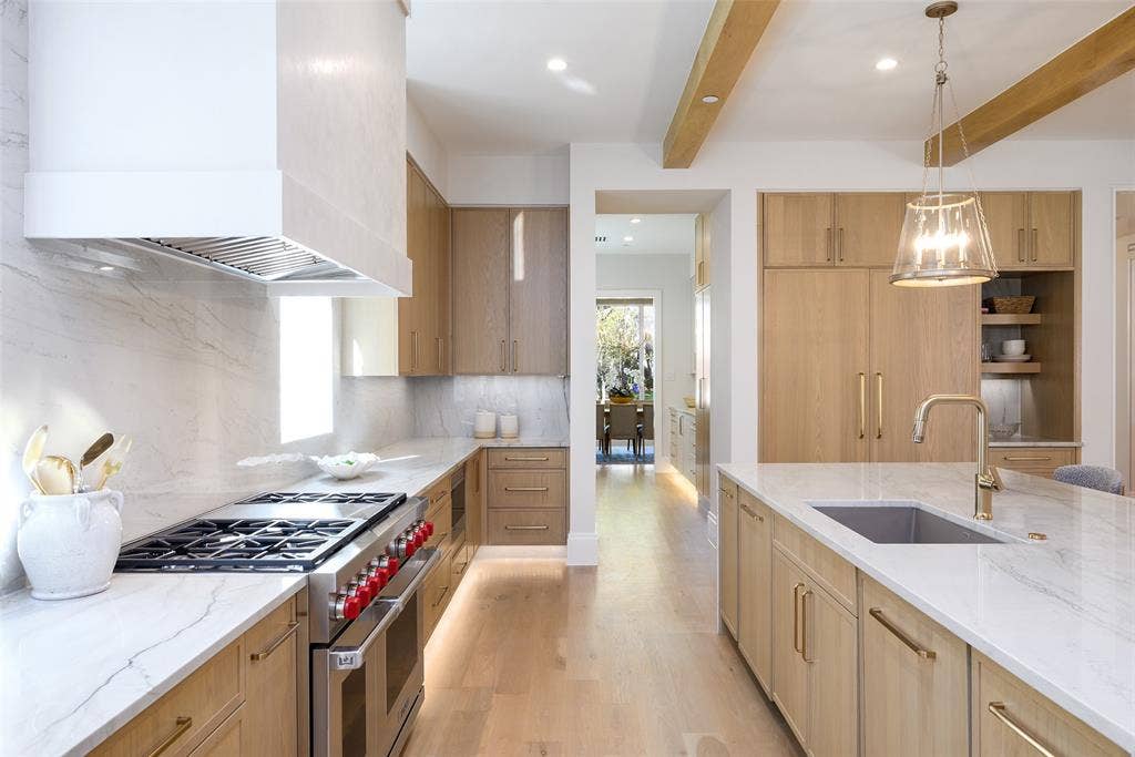 3929 Stanford Avenue, University Park, TX 75225 Gourmet culinary kitchen with custom slim Shaker, white oak cabinetry with soft-close doors and drawers, natural stone countertops with waterfall detail at island