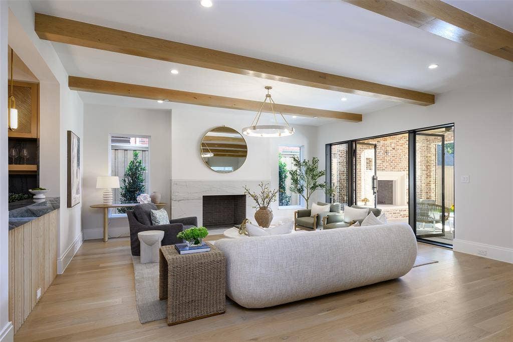 3929 Stanford Avenue, University Park, TX 75225 Large, open family living room with Isokern Magnum wood-burning fireplace with leathered natural stone slab surround and hearth