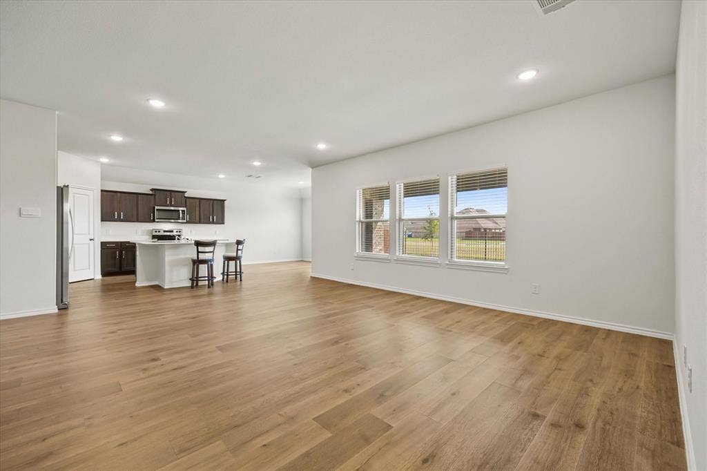 164 Mapleoak Drive, Caddo Mills, TX 75135 Banks of windows provide an abundance of natural lighting in family room.