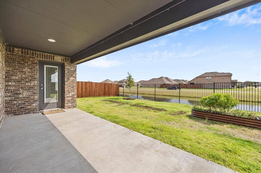 164 Mapleoak Drive, Caddo Mills, TX 75135 Extended patio overlooks private backyard and neighborhood canal!