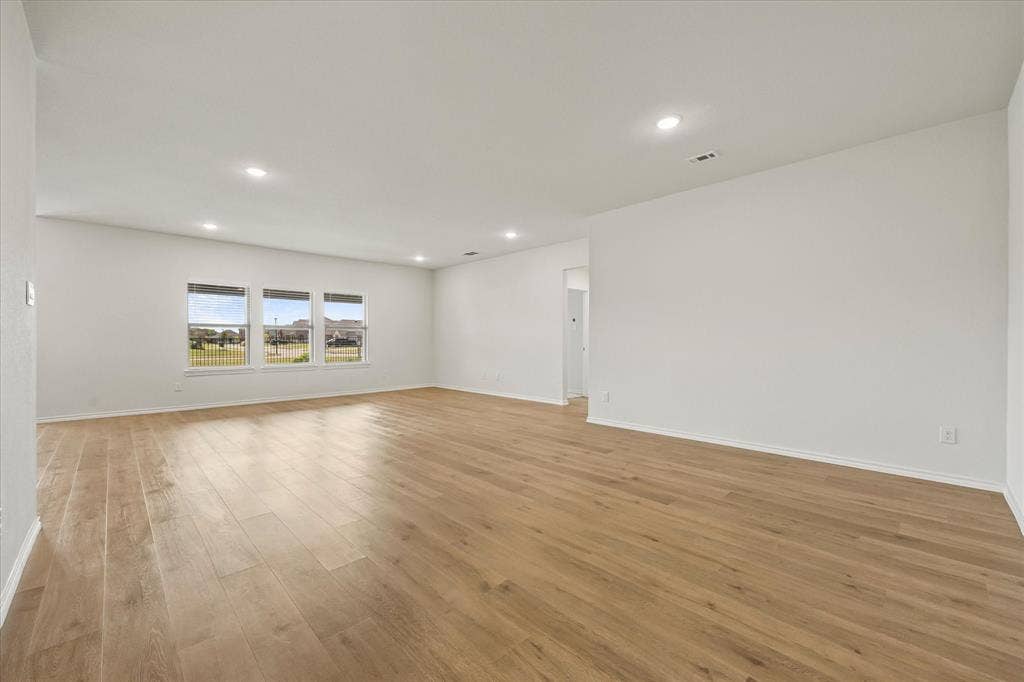 164 Mapleoak Drive, Caddo Mills, TX 75135 Open floor plan features dining area opening onto family room