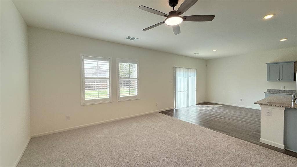 613 Delaware Avenue, Princeton, TX 75407 Vaulted ceilings, a ceiling fan with integrated lighting, recessed lighting, and wood-finish flooring