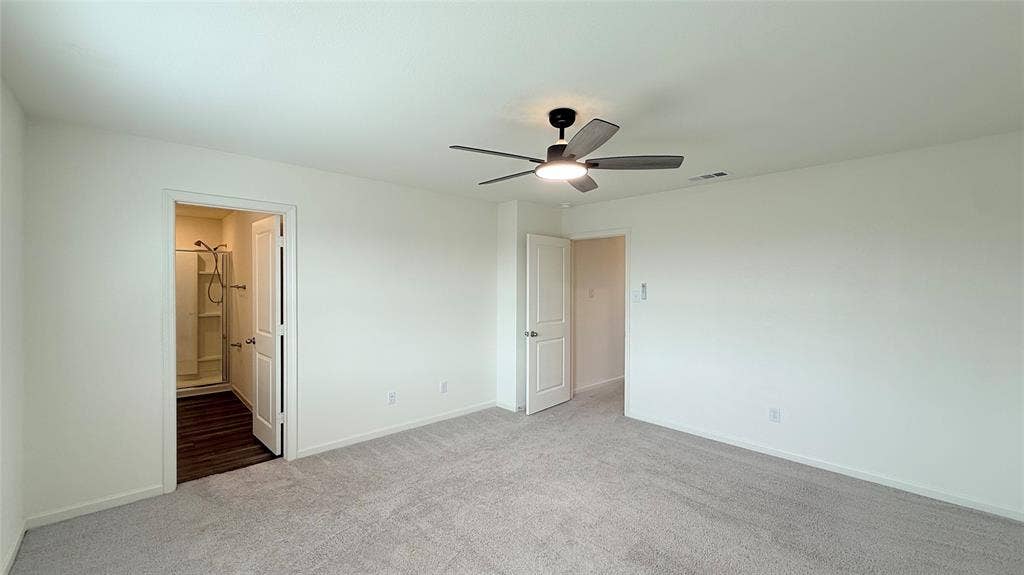 613 Delaware Avenue, Princeton, TX 75407 Spacious room featuring light-toned carpet, a contemporary ceiling fan with integrated lighting, and white walls