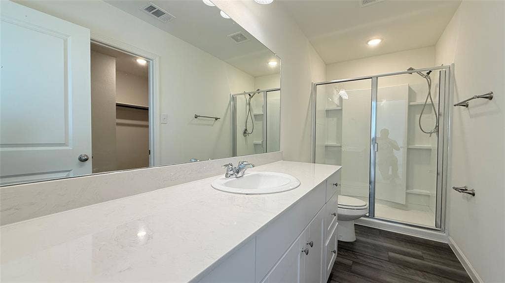 613 Delaware Avenue, Princeton, TX 75407 Vanity with an integrated sink, polished chrome faucet, and quartz-finish countertop