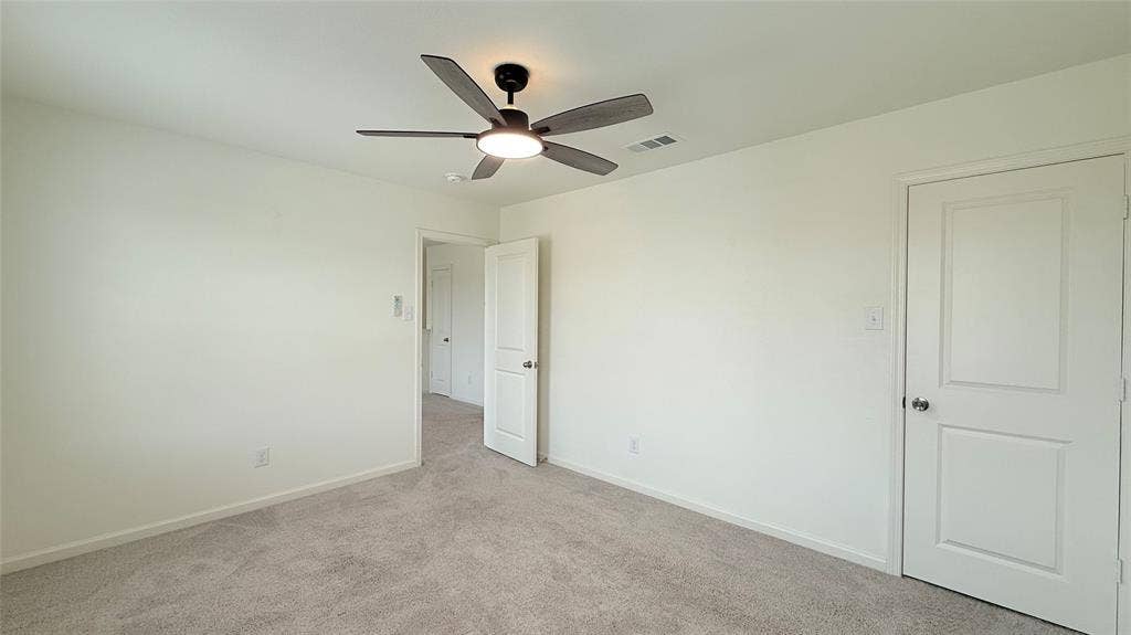 613 Delaware Avenue, Princeton, TX 75407 Recessed ceiling fan with integrated lighting, soft grey carpeting, and white paneled doors