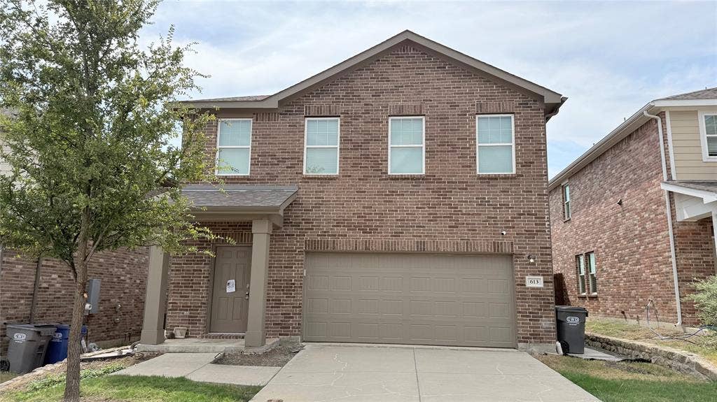 613 Delaware Avenue, Princeton, TX 75407 Brick exterior with a covered entry, attached garage, concrete driveway, and front walk