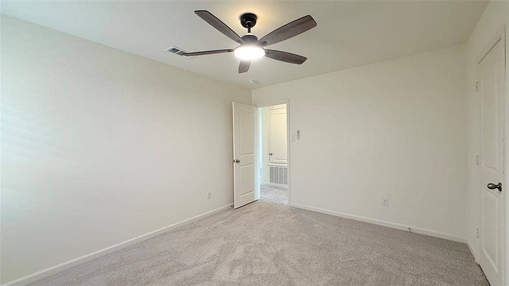 613 Delaware Avenue, Princeton, TX 75407 Neutral-toned walls complemented by plush carpeting