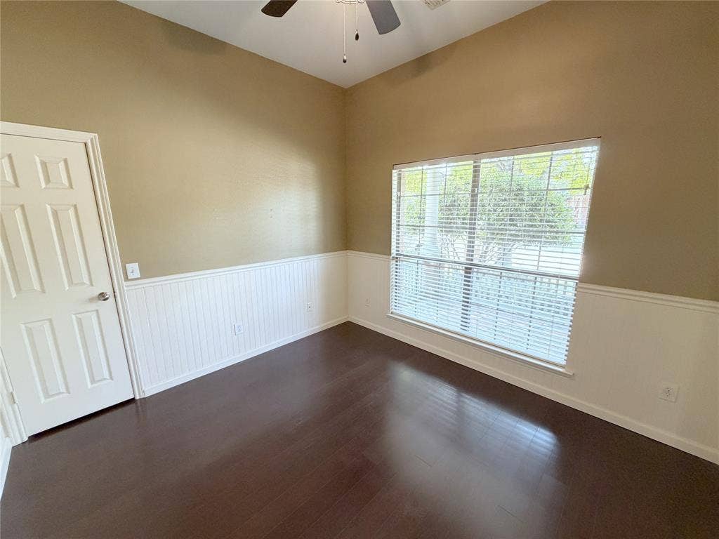 8100 Purple Martin Way, McKinney, TX 75072 Vaulted ceiling with an attached ceiling fan, wood-finish flooring, and panel wainscoting