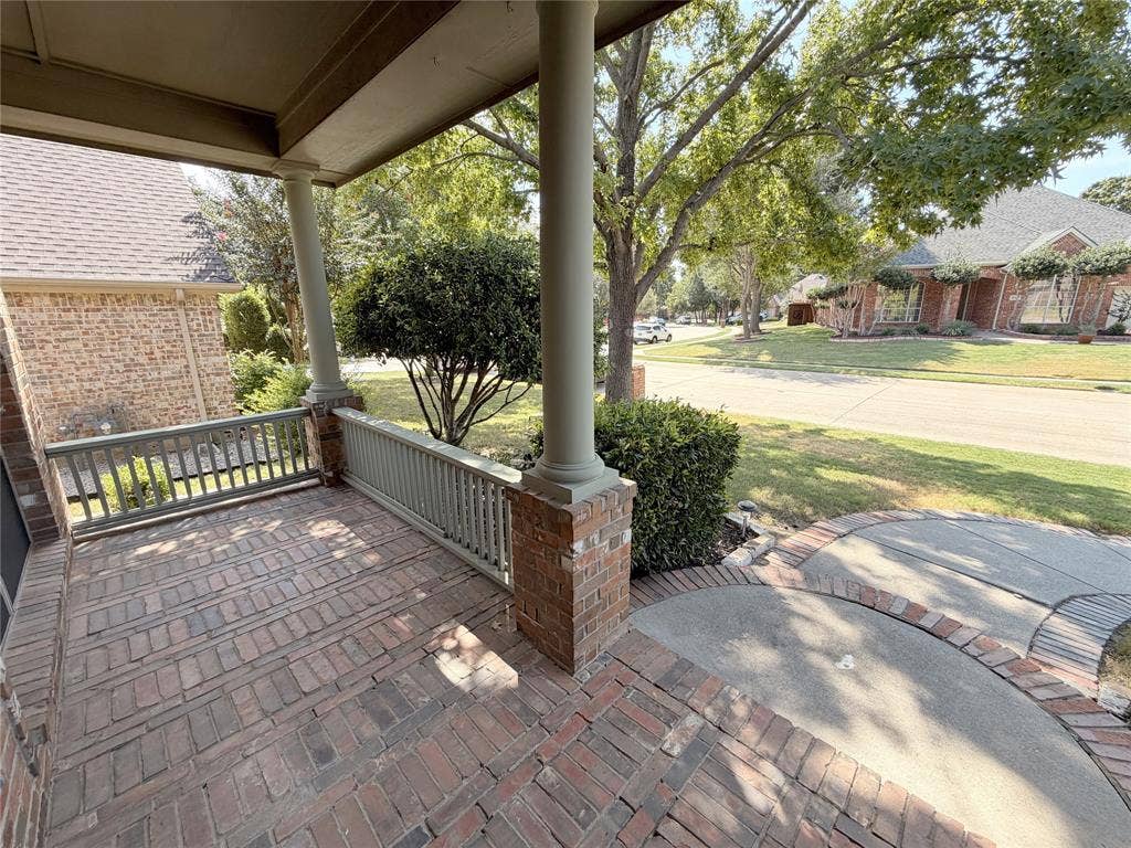 8100 Purple Martin Way, McKinney, TX 75072 Brick-paved front porch with painted railings, brick columns, and a landscaped front yard