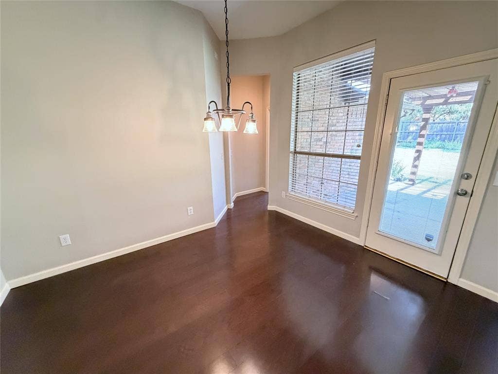 8100 Purple Martin Way, McKinney, TX 75072 Wood-finish flooring, full-light exterior door, window with blinds, and a multi-light chandelier