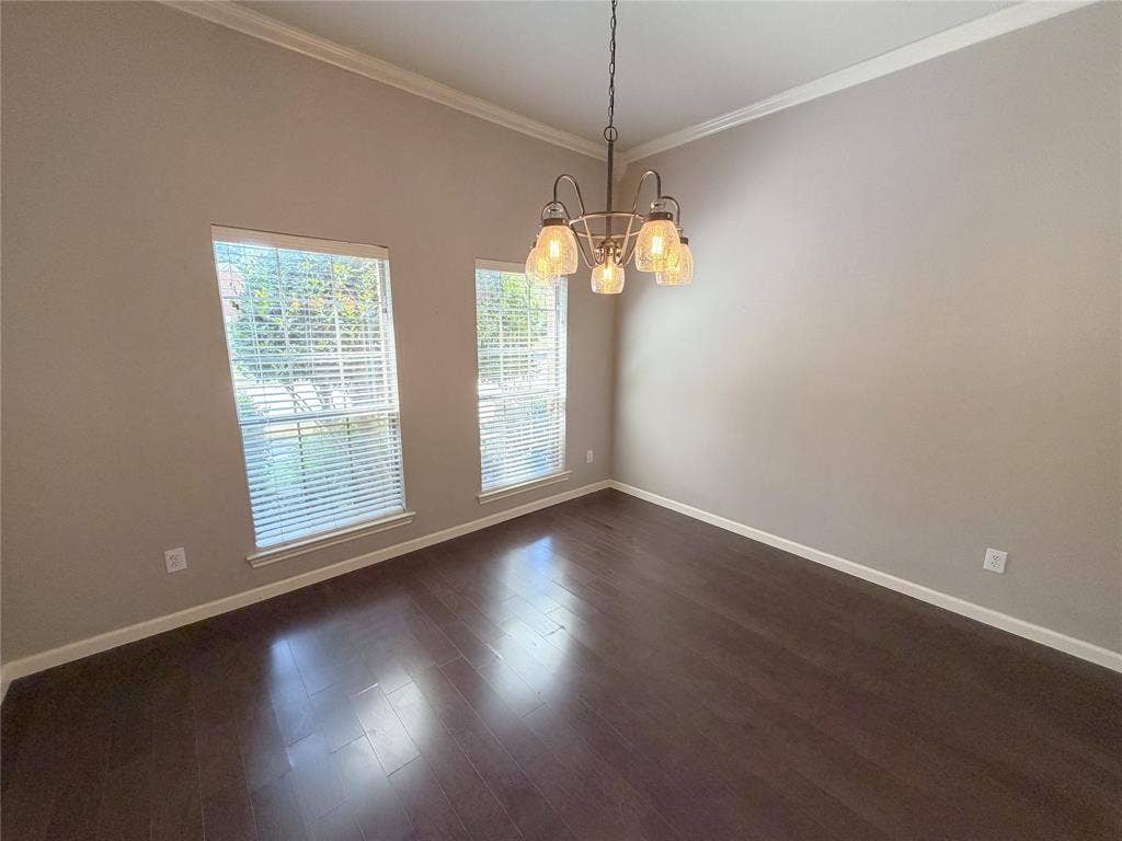 8100 Purple Martin Way, McKinney, TX 75072 Hardwood-finish flooring, crown molding, two windows with blinds, and an overhead chandelier