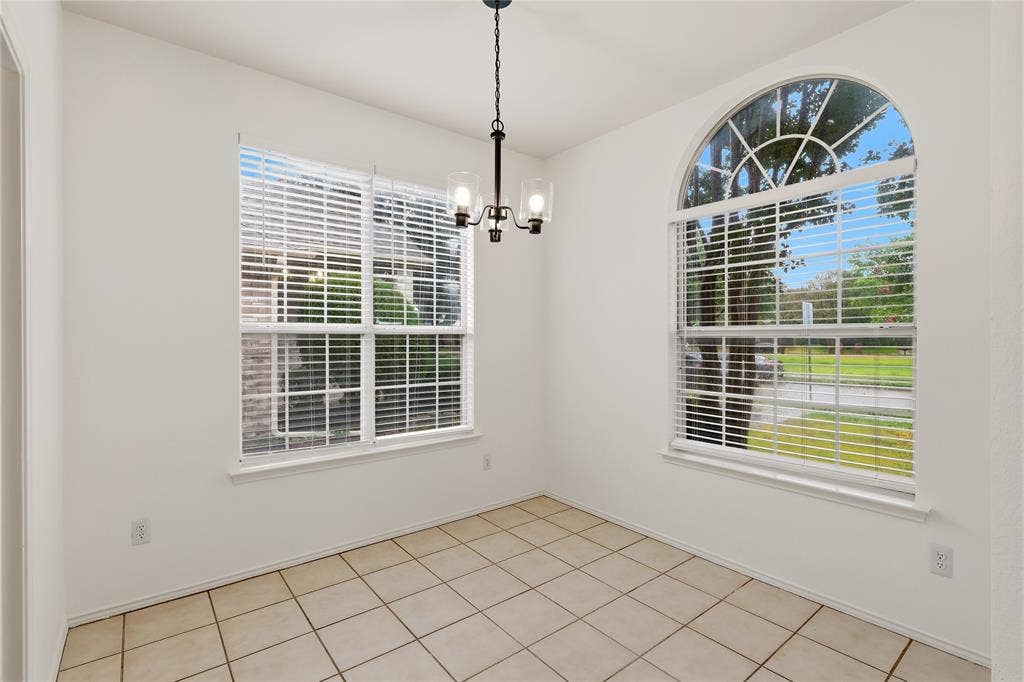 9105 Norman Drive, Plano, TX 75025 Tiled flooring complemented by a prominent arched window and a standard rectangular window