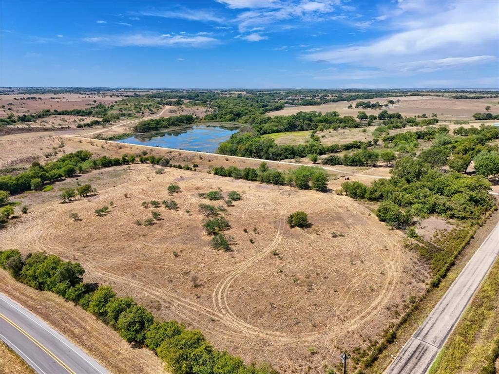 TBD Horne Hill Road, Moody, TX 76557 Expansive land featuring a natural pond, scattered mature trees, and direct road frontage