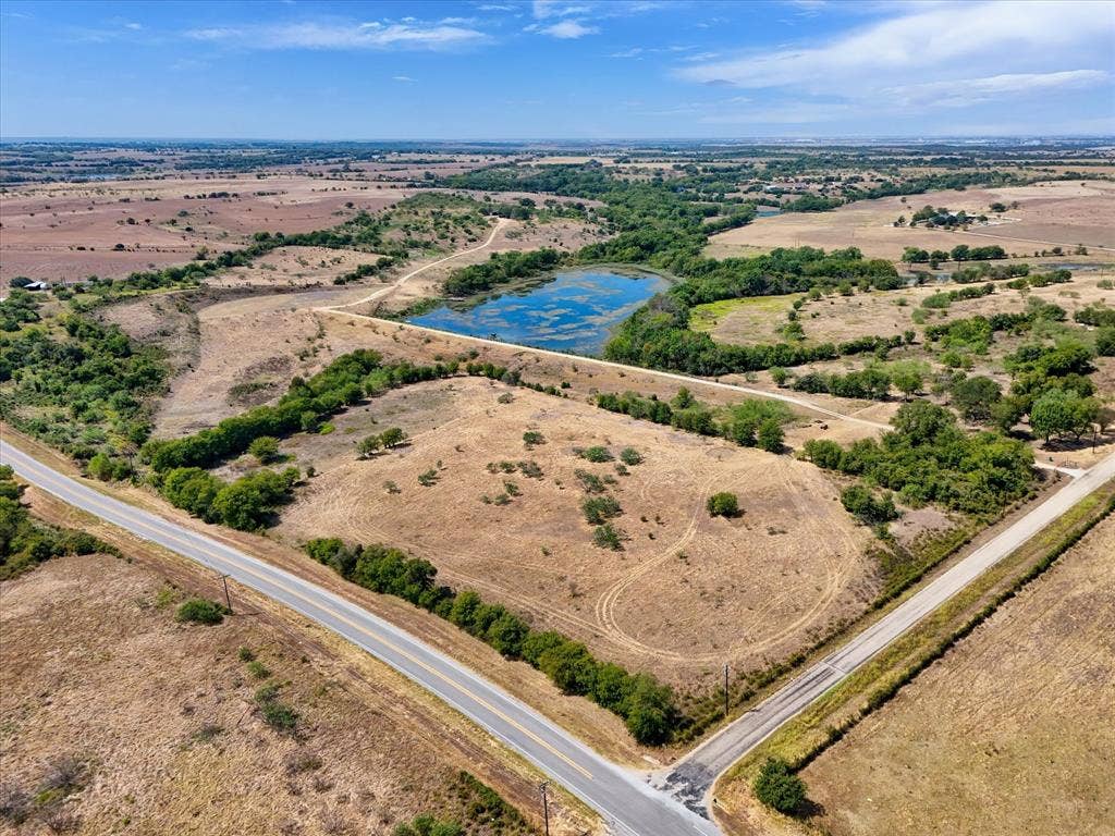 TBD Horne Hill Road, Moody, TX 76557 Expansive land featuring a natural pond, established trees, and paved road frontage