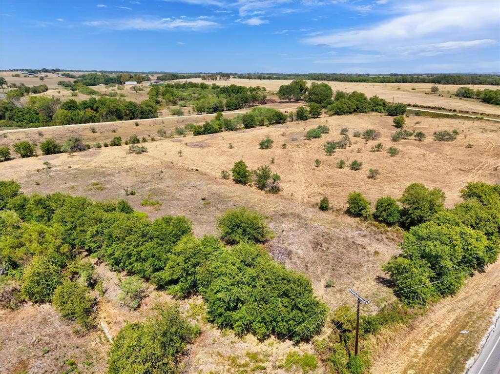 TBD Horne Hill Road, Moody, TX 76557 Expansive acreage featuring mature trees and open land, bordered by a paved road
