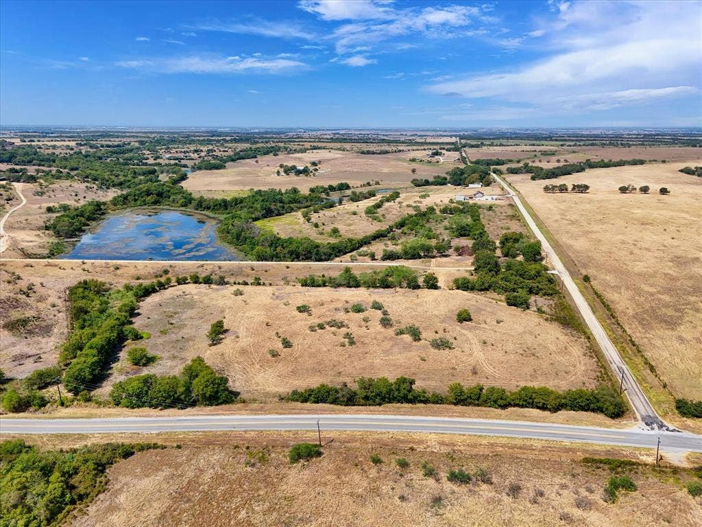 TBD Horne Hill Road, Moody, TX 76557 Expansive parcel featuring a natural pond, established tree lines, and open fields with a paved road frontage