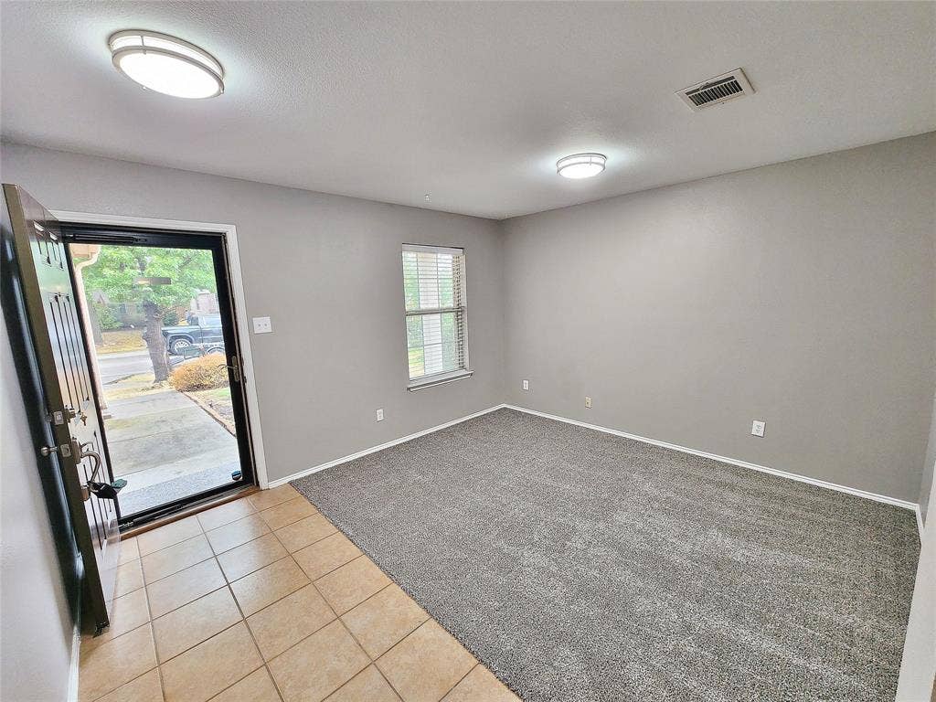 1229 Pine Forest Drive, Princeton, TX 75407 Entry area featuring tile flooring, leading to a room with neutral gray carpeting