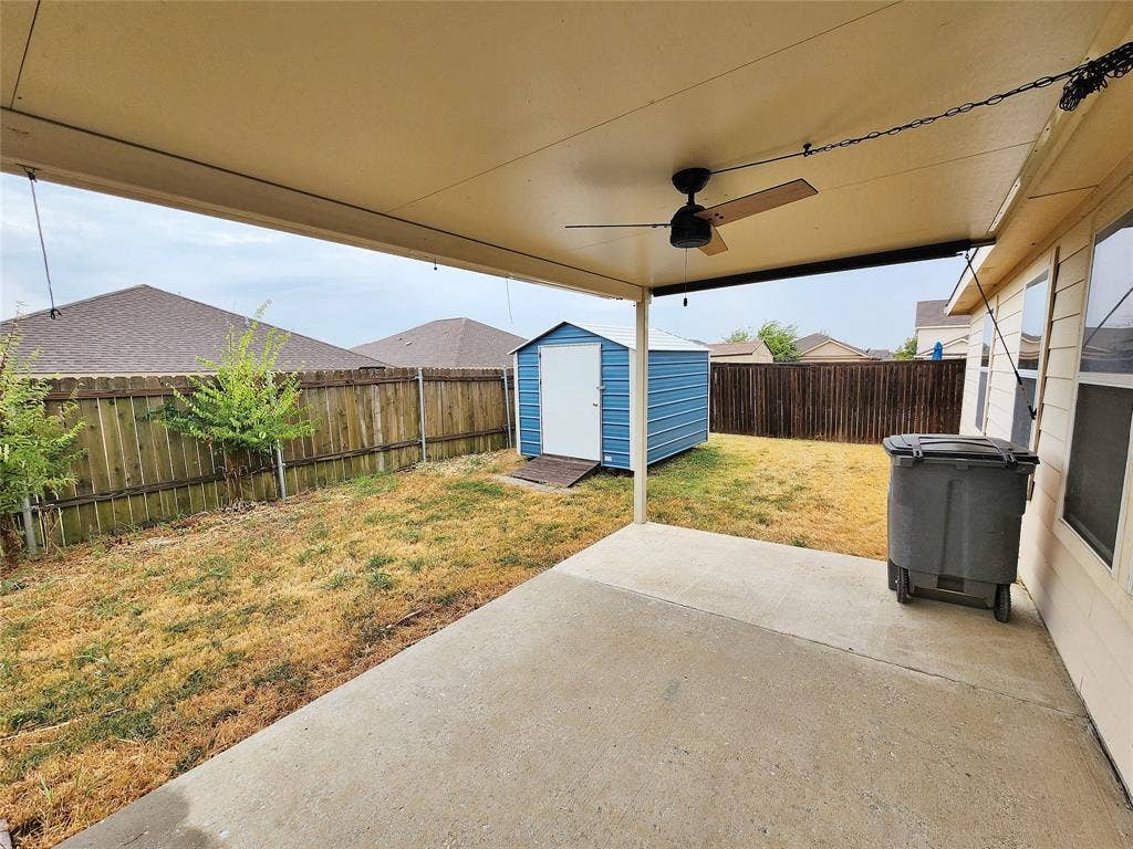 1229 Pine Forest Drive, Princeton, TX 75407 Covered patio with a ceiling fan, concrete flooring, and a storage shed